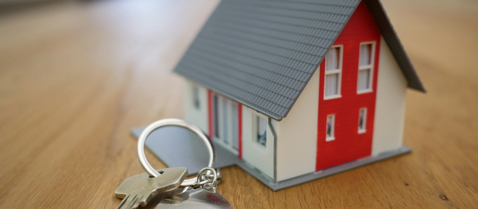 A model home and keys, representing protection for a home loan