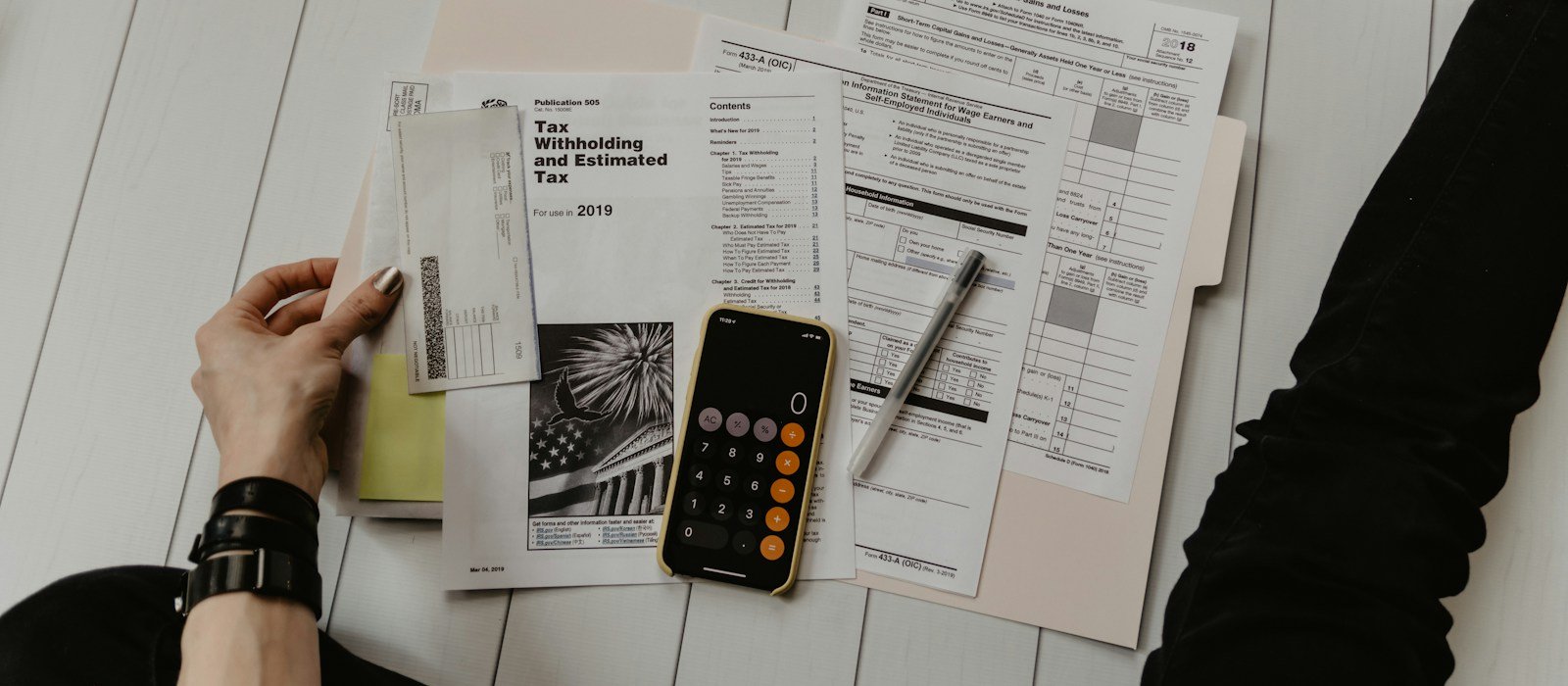 A calculator and financial records used to plan regular savings