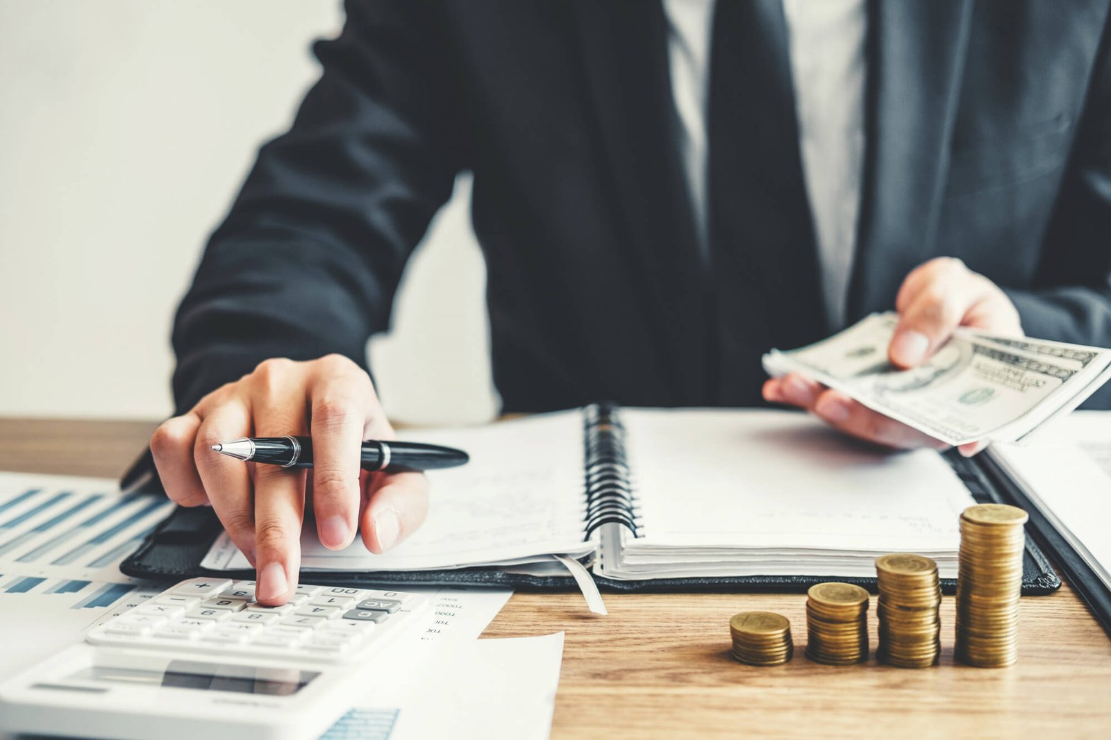 Cash and coin stacks representing periodic income and money-back planning